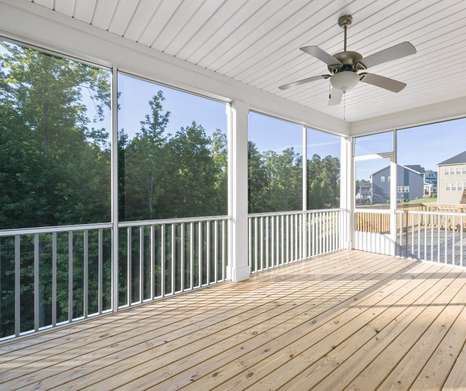 Screened-in porch with wood decking and railing system demonstrating how a deck builder integrates structure and airflow while avoiding common deck construction mistakes in covered outdoor spaces