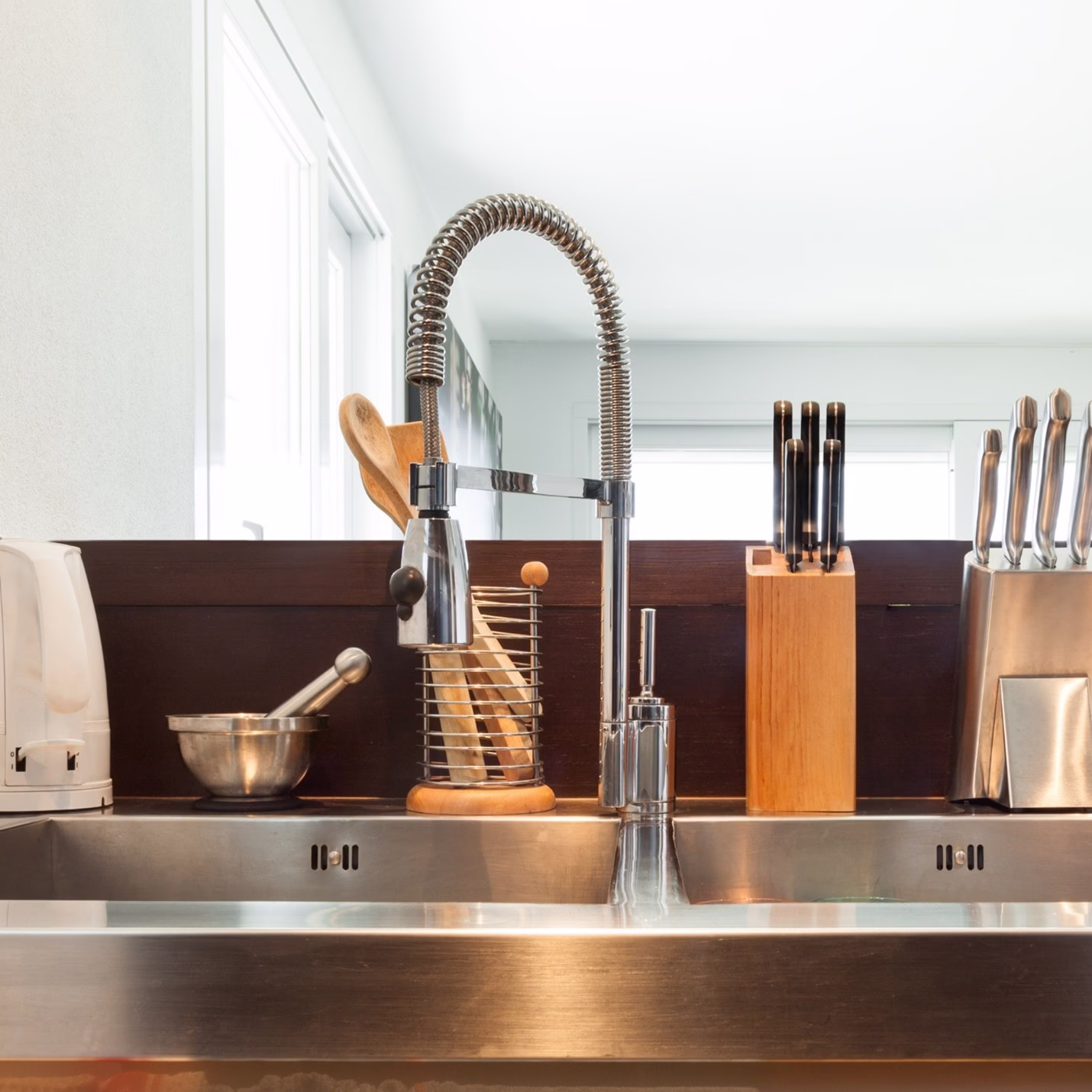 Large stainless steel kitchen sink with commercial-style faucet highlighting durable kitchen sink materials and choosing a kitchen sink that supports daily kitchen workflow in a kitchen remodel College Station project