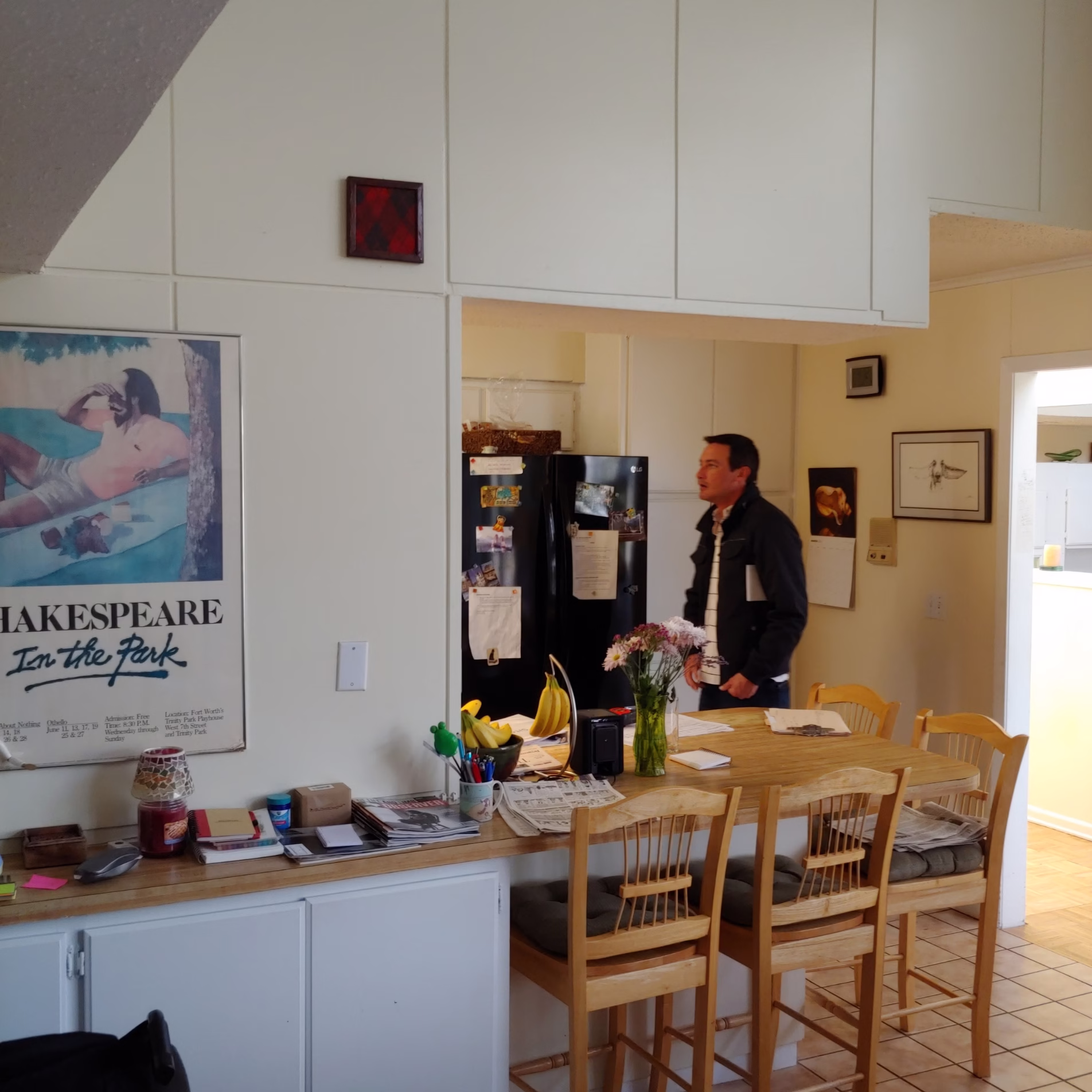 Before view of the kitchen and dining area with a partial wall separating the kitchen from the adjoining family room.