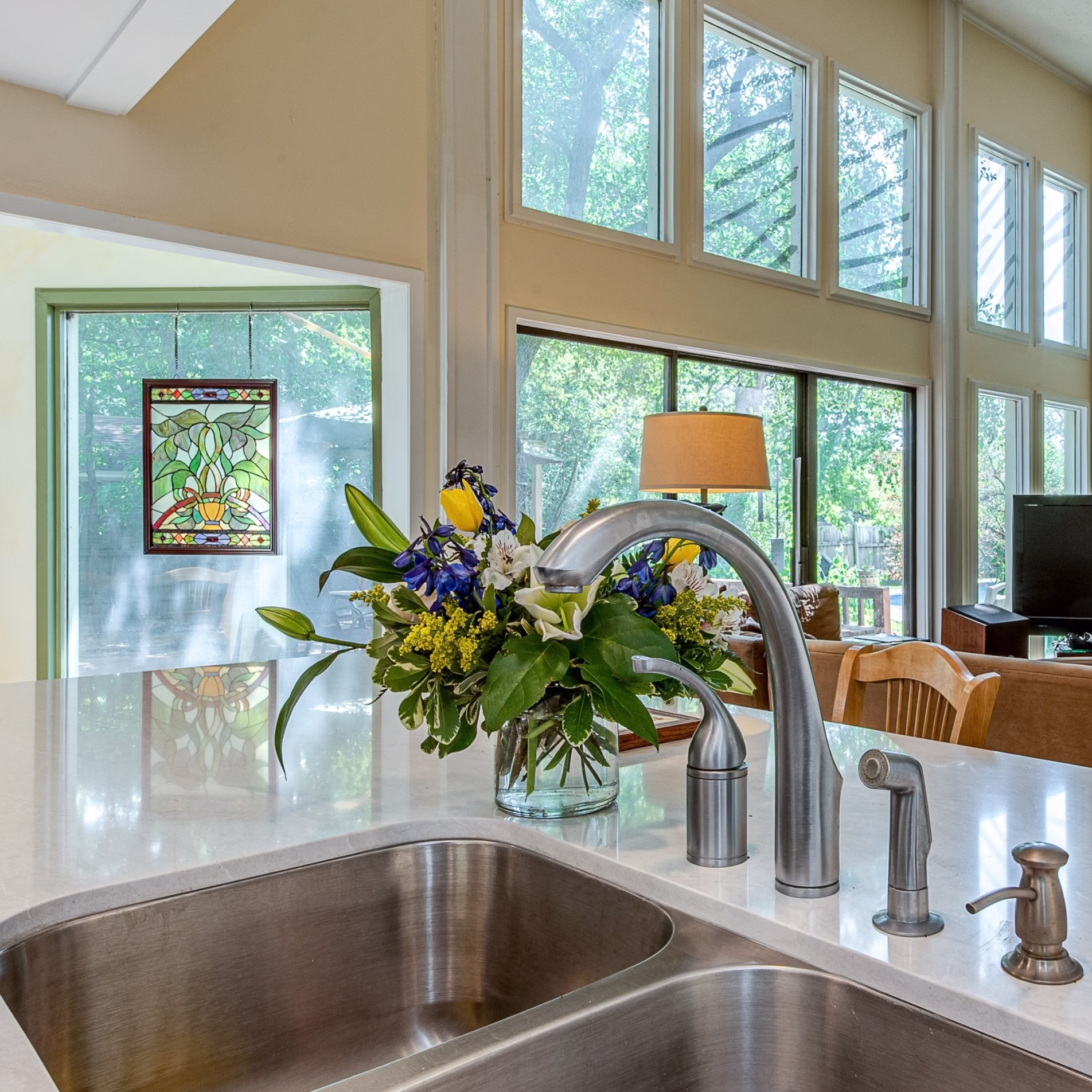 College Station kitchen remodel with double-basin sink overlooking the bright family room and its large windows.