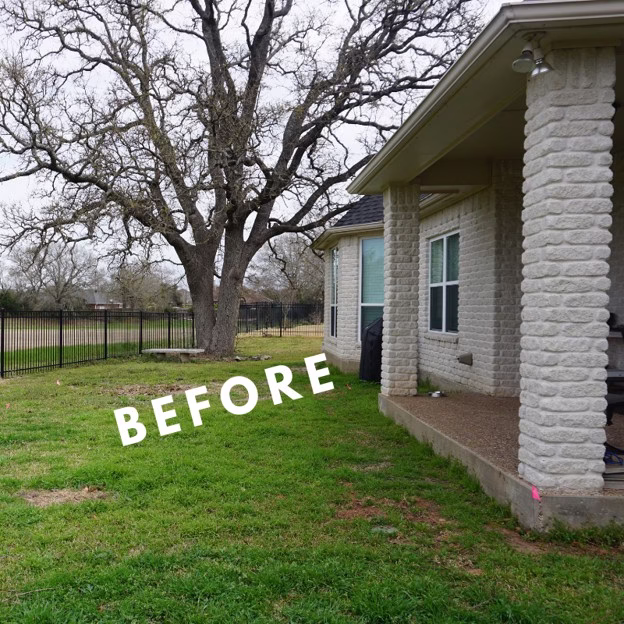 Backyard before a custom patio design in College Station featuring the home's original covered concrete patio.