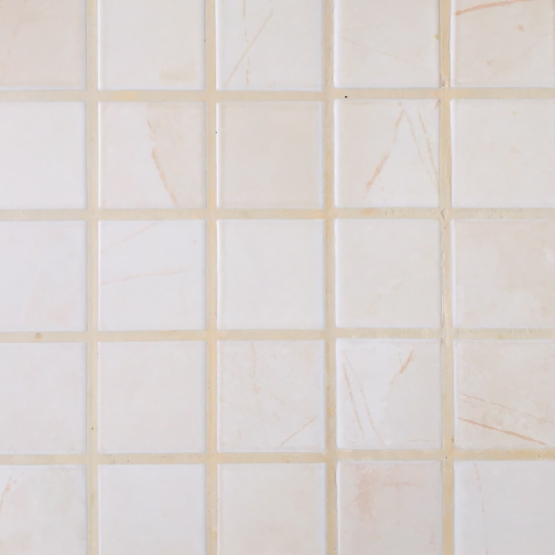 Cream square tile with light beige grout for a subtle, low-contrast appearance.