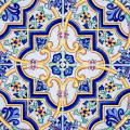 Colorful patterned tile with light grout separating the repeating decorative design.
