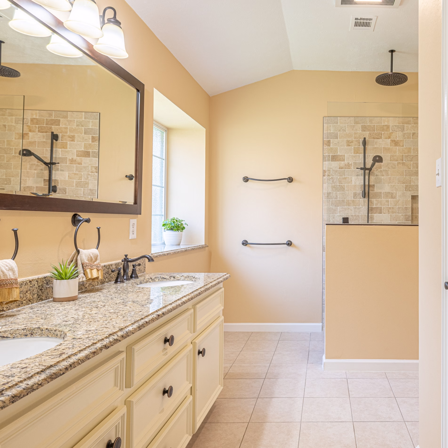 Remodeled primary bathroom where the former bathtub area was converted into a spacious tiled shower