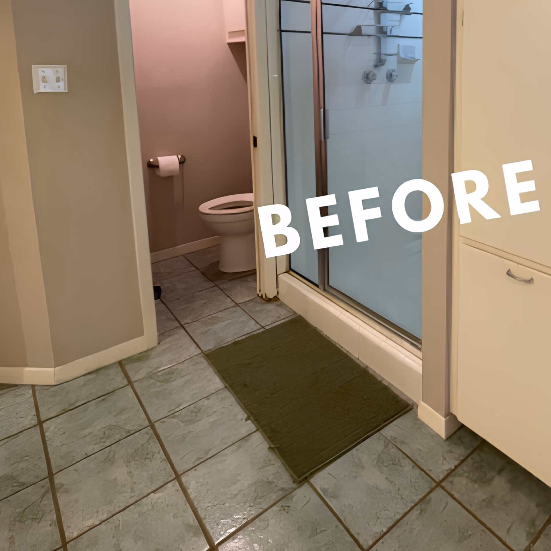 Original gray bathroom floor tiles beside the raised shower threshold before the aging-in-place bathroom remodel.