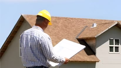Contractor reviewing plans during a home remodel in College Station while developing an accurate remodeling budget through a detailed remodeling estimate process