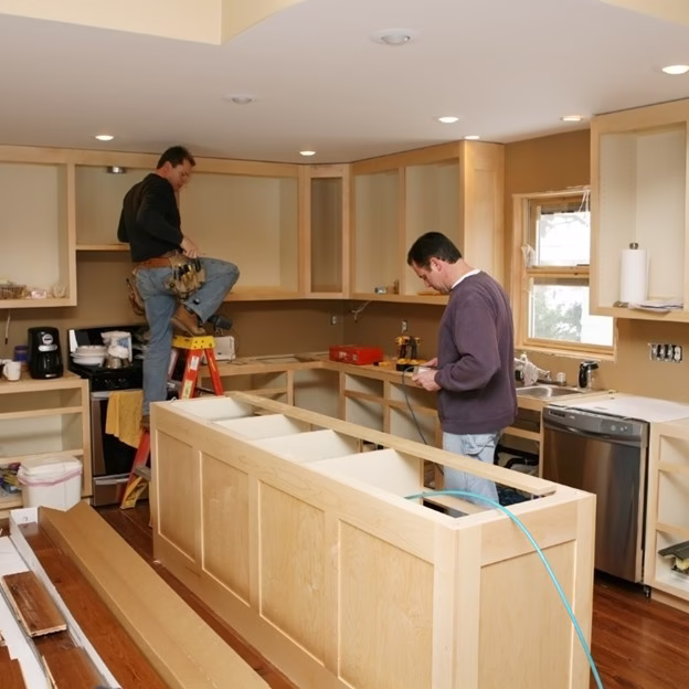 Kitchen under construction showing cabinet installation phase that homeowners should expect during a kitchen remodel
