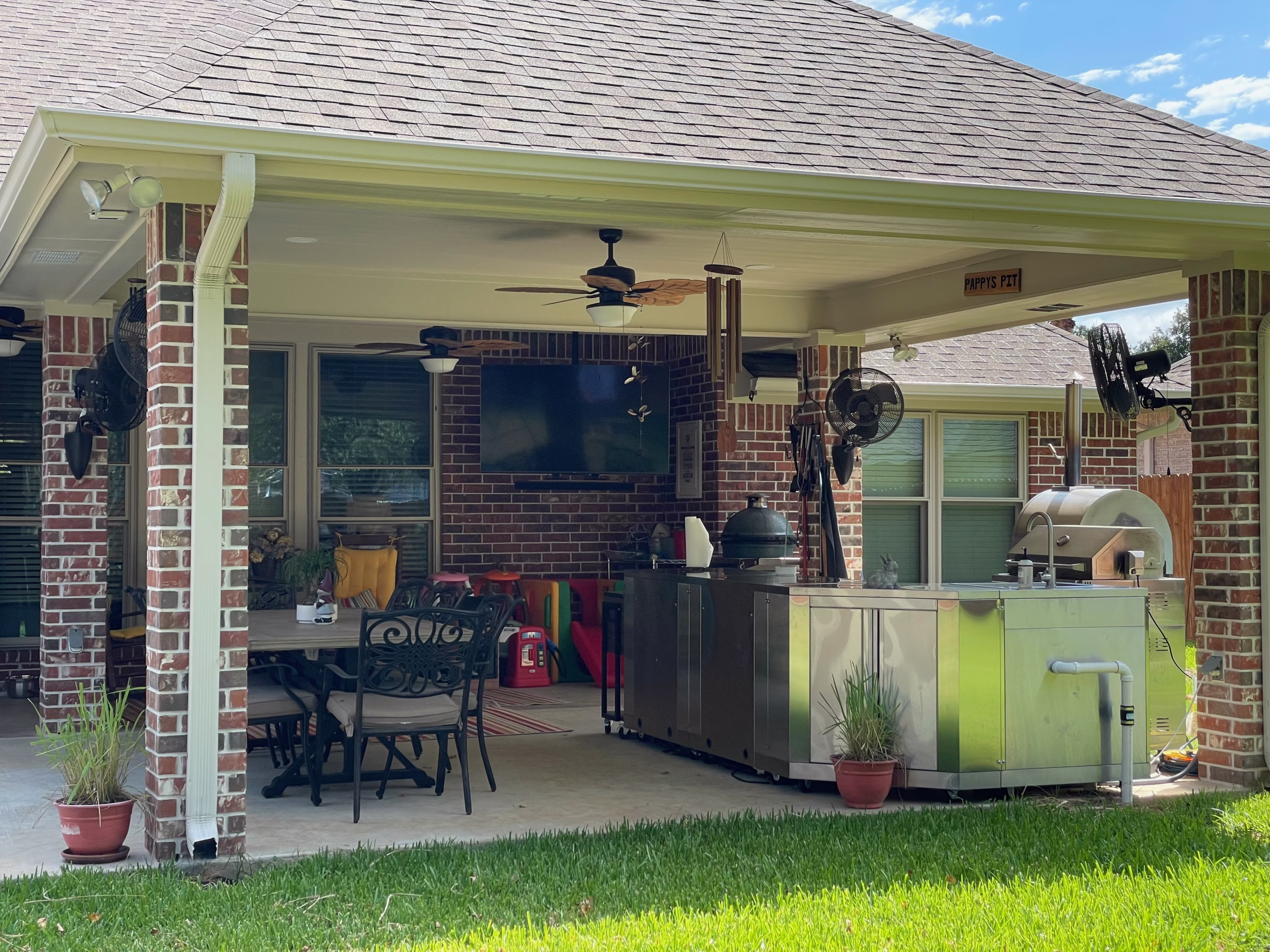 Covered outdoor kitchen addition illustrating integration of new living space with the existing home.