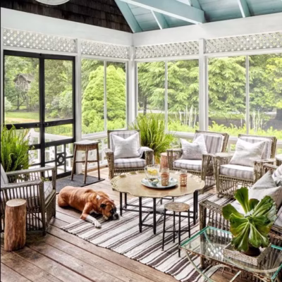 Connection to nature in home design through a screened porch that allows fresh air, natural light, and views of surrounding greenery
