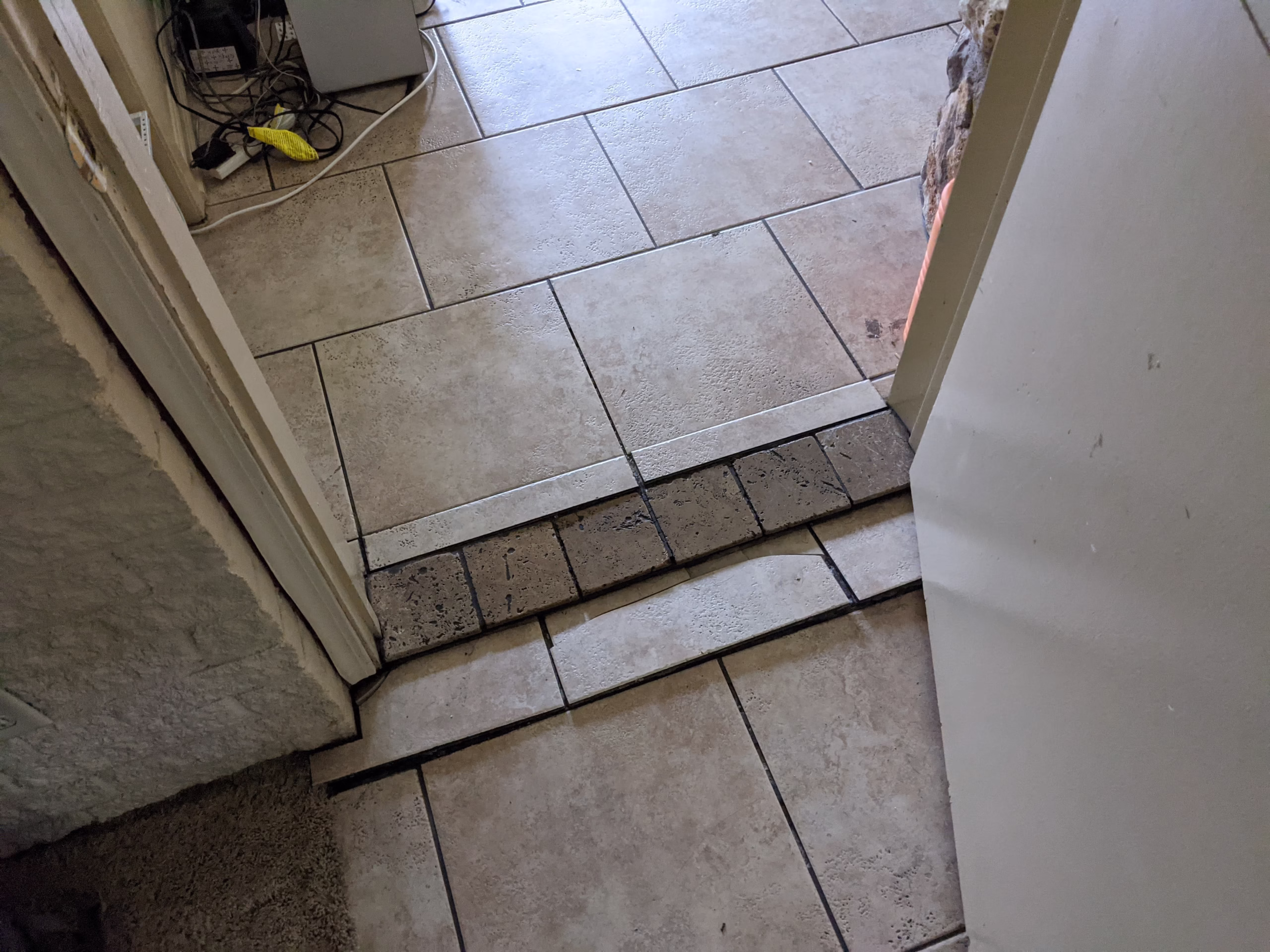Uneven flooring transition before corrections made during aging in place home renovations.