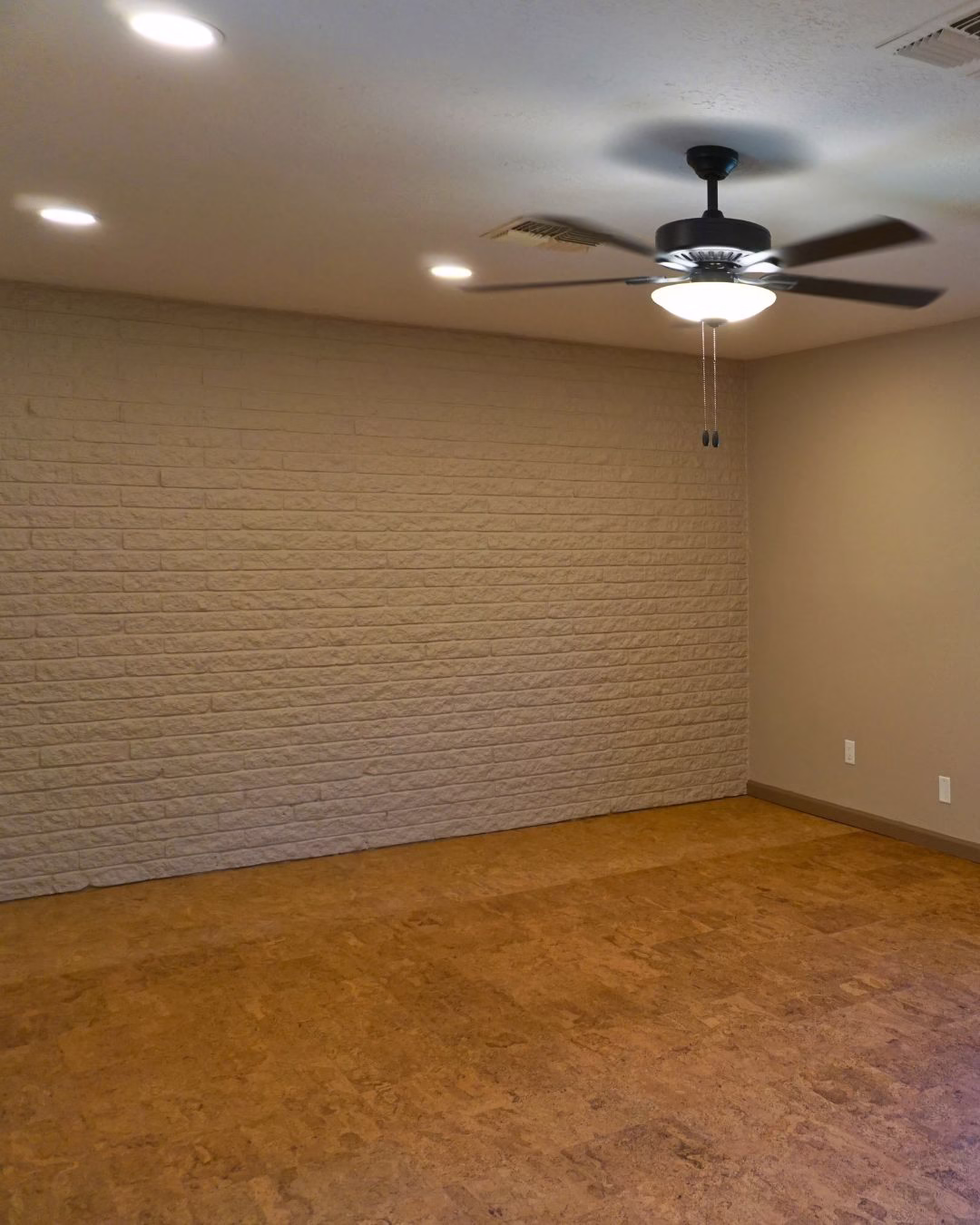 Bedroom after aging in place renovation with recessed lighting and updated ceiling fan to improve visibility and safety.