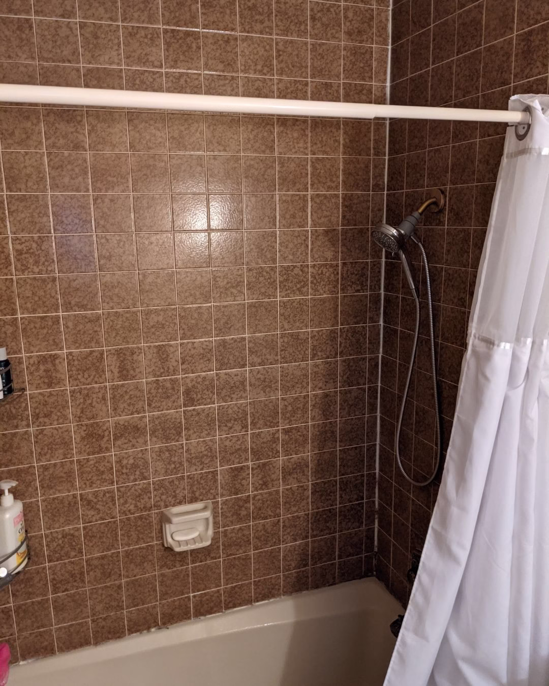 Traditional tub and shower combination before aging in place bathroom renovation.