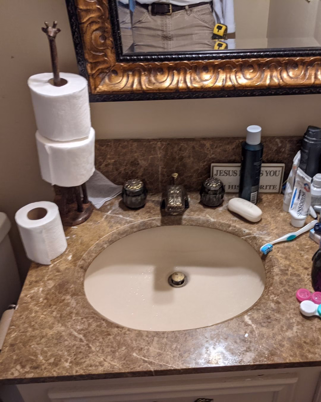 Bathroom vanity with cabinet base before aging in place renovations to improve wheelchair accessibility.