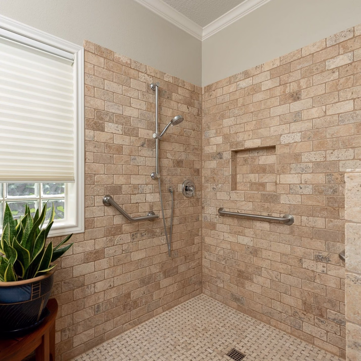 Walk in shower with tile walls, integrated grab bars, and a low pony wall illustrating accessibility considerations during bathroom remodel planning