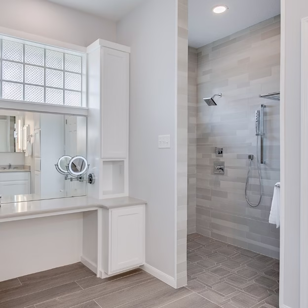 Modern bathroom remodel featuring vinyl and tile bathroom flooring with walk-in shower, illustrating durable bathroom floor installation