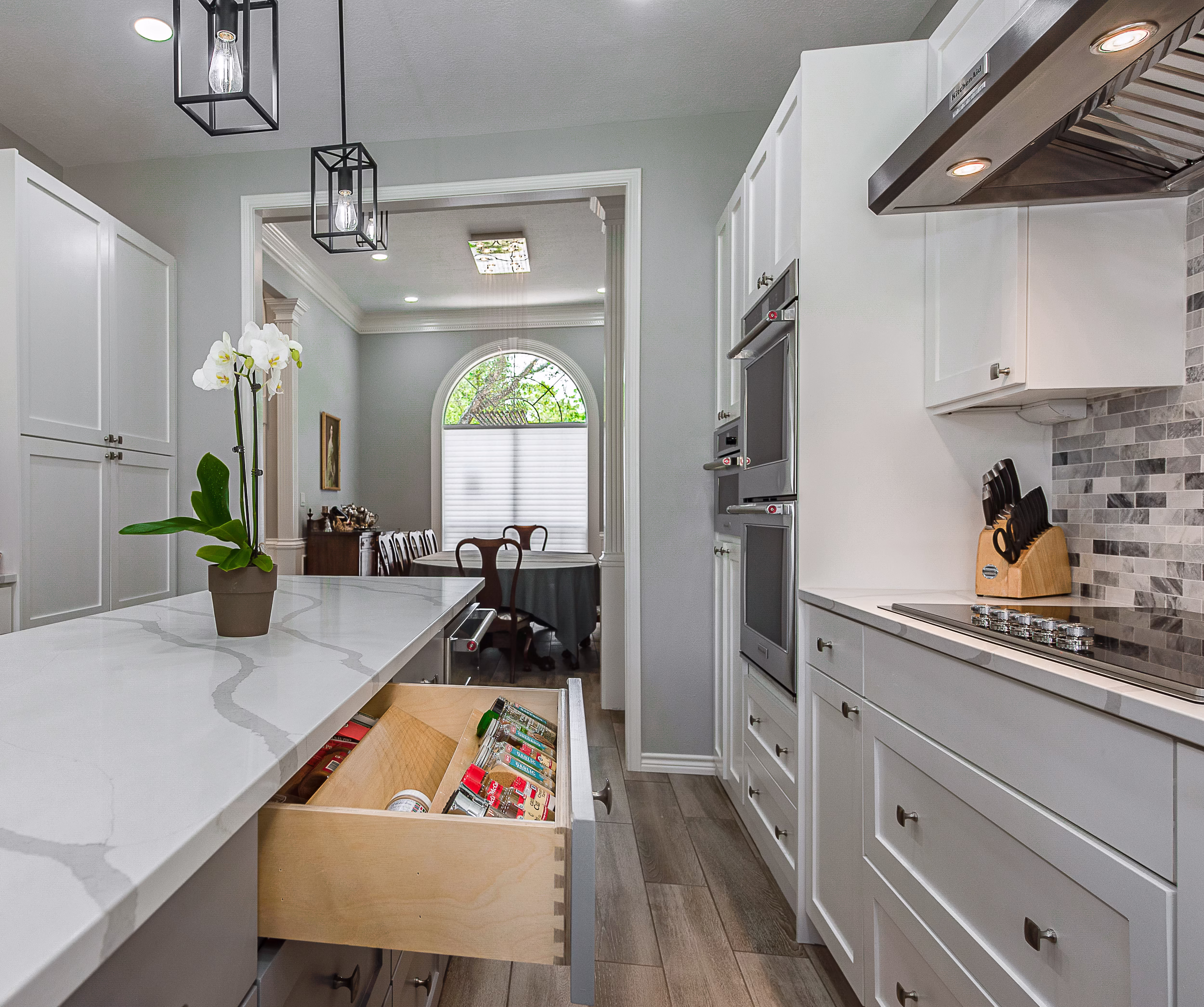 Kitchen storage ideas shown through a custom spice drawer placed across from the cooktop, illustrating practical storage ideas in the kitchen for everyday cooking routines.