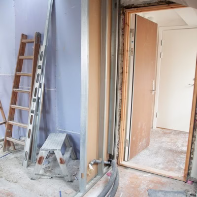 Interior remodeling site with exposed framing and tools demonstrating early-stage work by a general contractor in Bryan