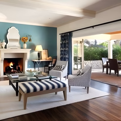 Transitional living room with soft blue accent wall, natural wood flooring, and connected indoor-outdoor views demonstrating interior color planning for a cohesive home remodel in College Station.