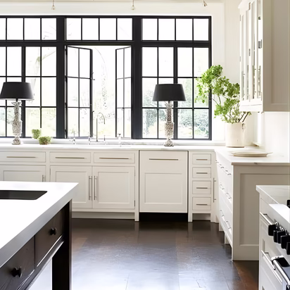 White kitchen with black framed windows and layered contrast showing how choosing colors for a remodel can emphasize architectural lines and create a timeless home remodel color palette in Bryan TX.