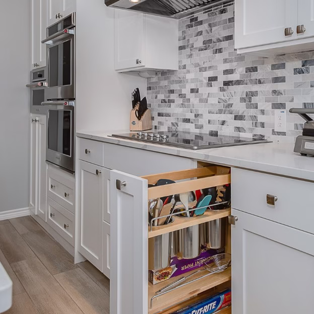 Modern kitchen after renovation with expanded island, updated lighting, and improved circulation throughout the whole home renovation