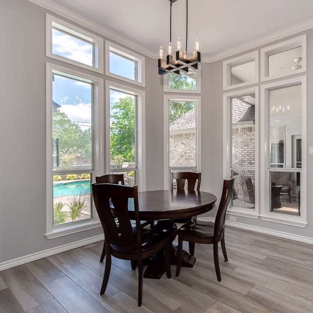 Breakfast nook after renovation with updated flooring, modern lighting, and brighter finishes in this Southwood Valley home renovation