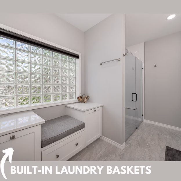 Primary bathroom after remodeling with built-in laundry baskets, dressing bench, and improved storage in this whole home remodel ideas project