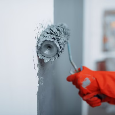 Surface preparation for painting with roller application during professional interior painting services to create a smooth and durable professional paint job