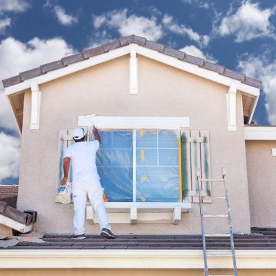 Professional exterior house painting contractor applying protective coatings to a Bryan College Station home for a long lasting paint finish and improved weather protection