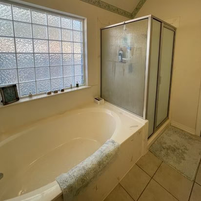 Existing soaking tub and enclosed shower before an accessible bathroom remodel, highlighting the layout that would later be redesigned for aging in place.