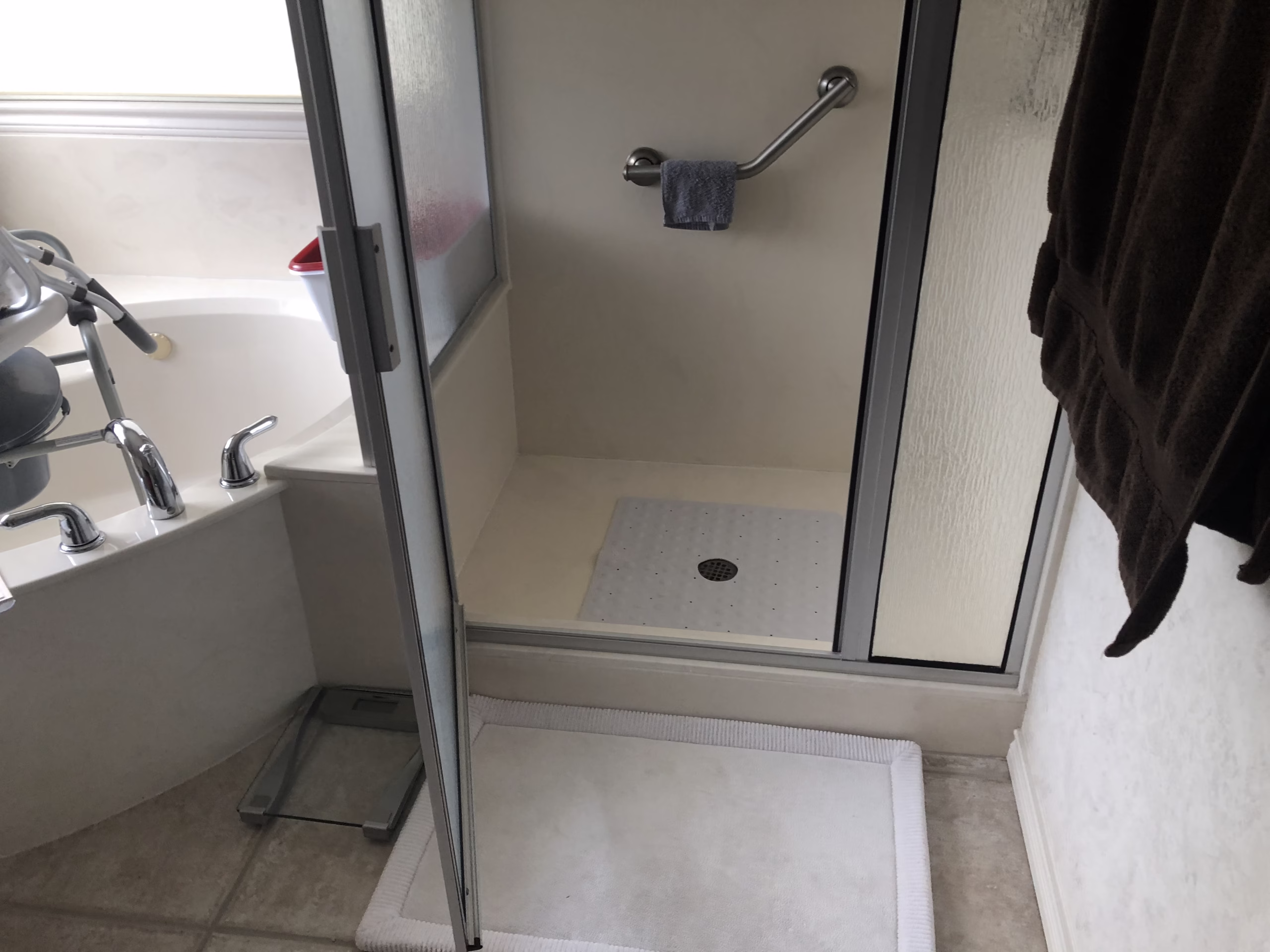 Before an aging in place bathroom remodel showing a traditional shower and bathtub layout with limited accessibility, highlighting the need for an accessible bathroom remodel in Bryan–College Station.