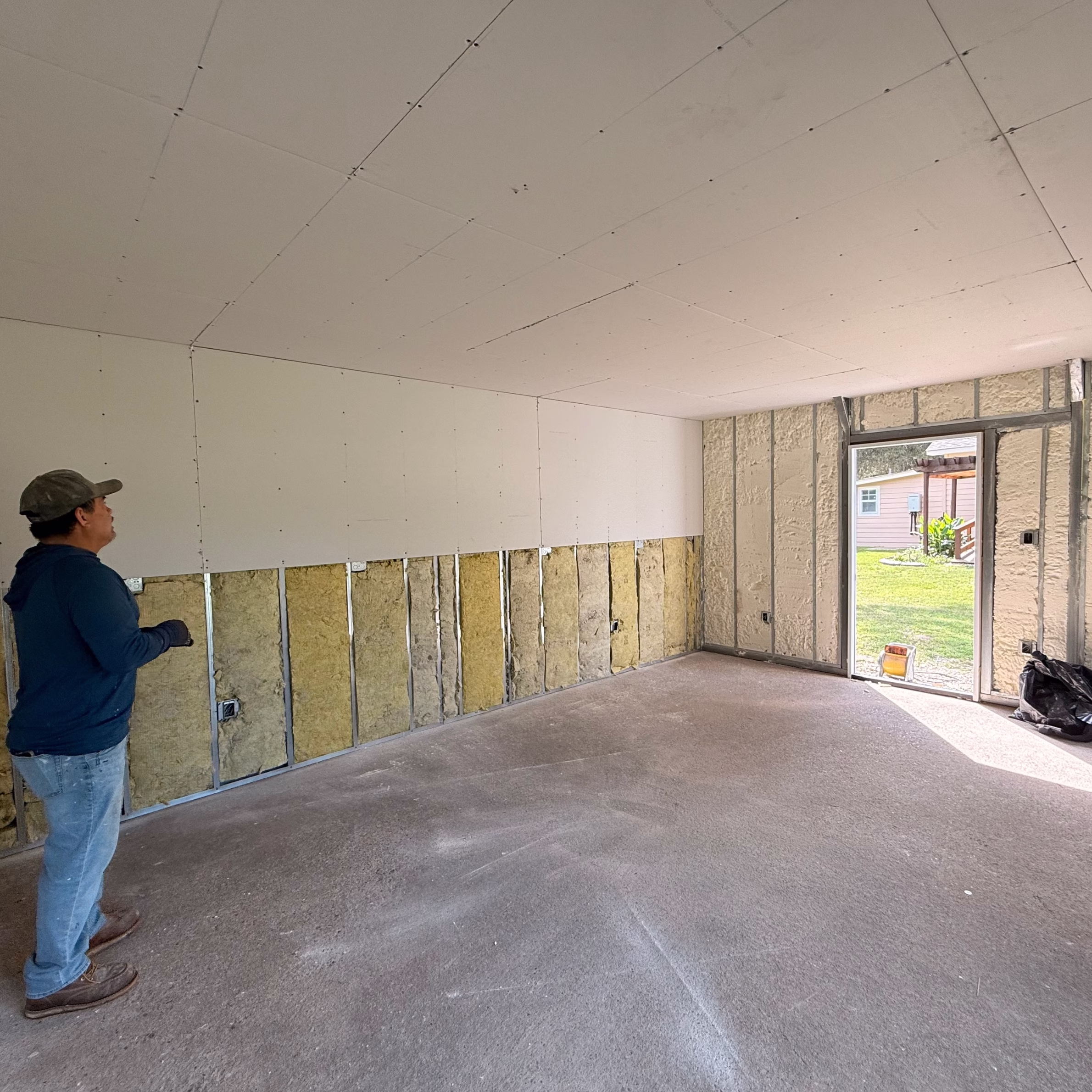 Home remodel in progress showing wall updates, insulation, and construction planning before creating a more functional living space