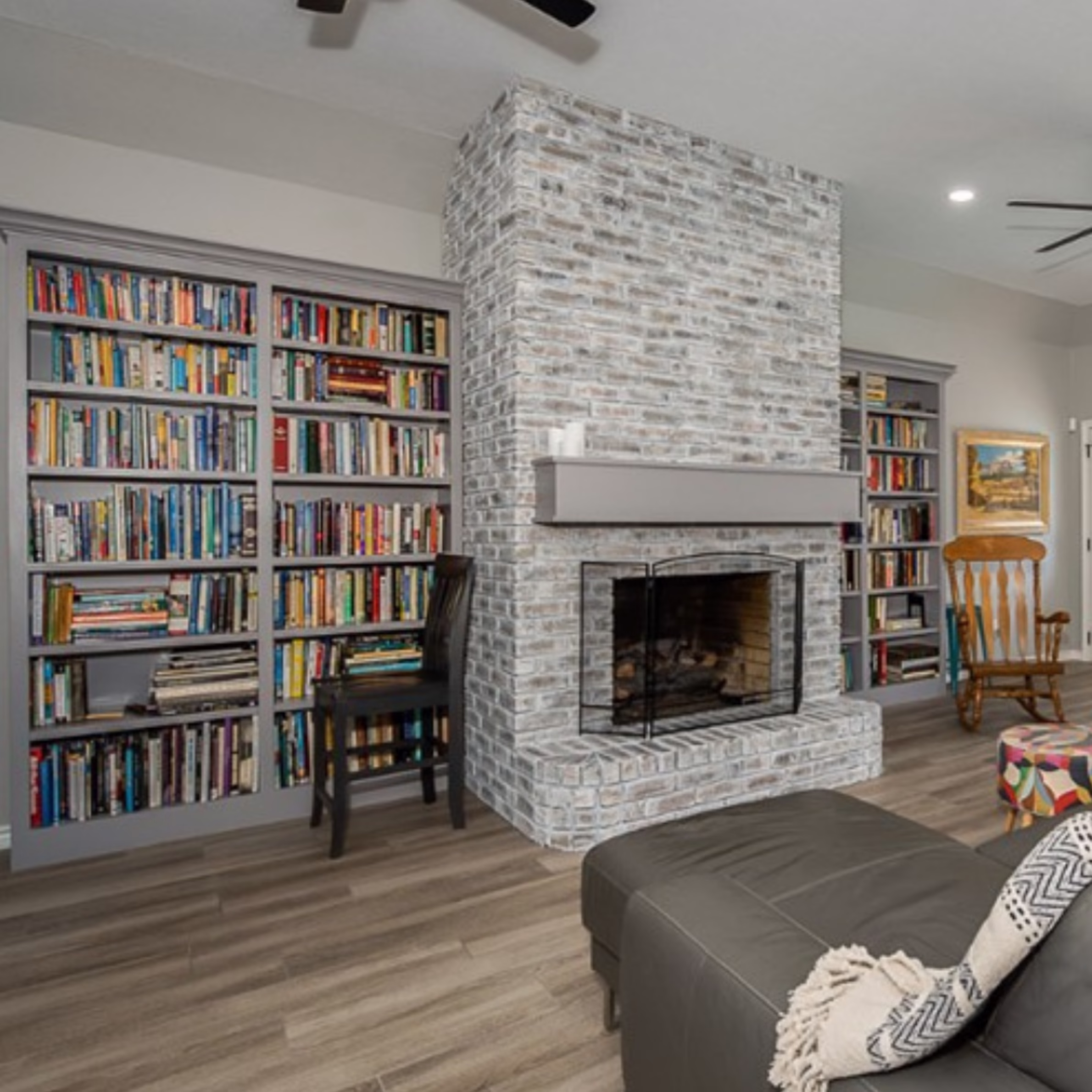 Completed home remodel with custom built-in bookshelves, updated fireplace, and personalized living space design