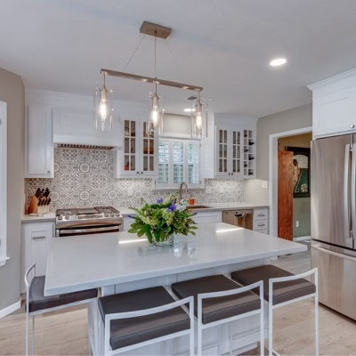Bright kitchen featuring recessed lighting, pendant lights, and layered illumination that supports aging-in-place design.