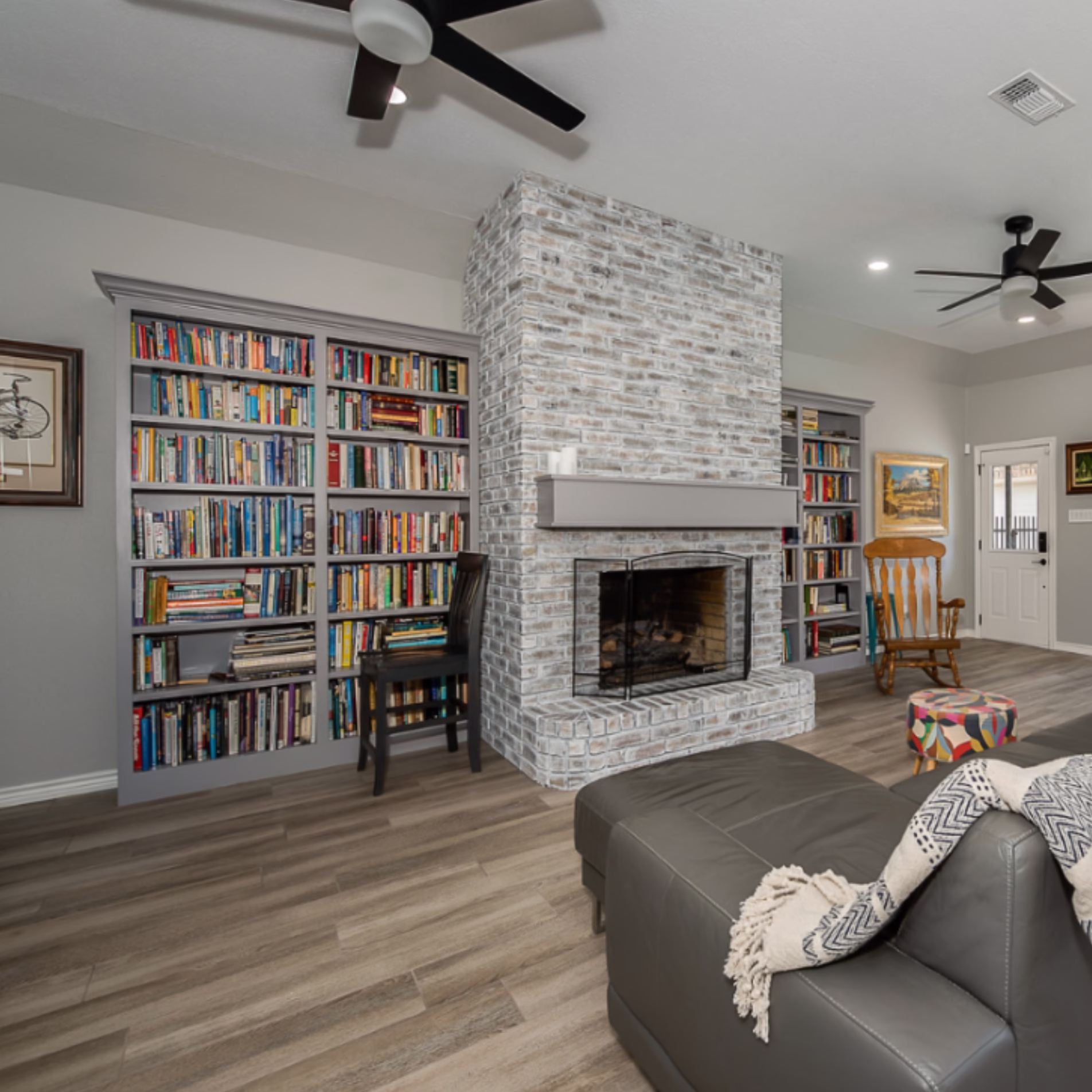 Interior living room with a whitewashed brick fireplace providing thermal mass inside the home.