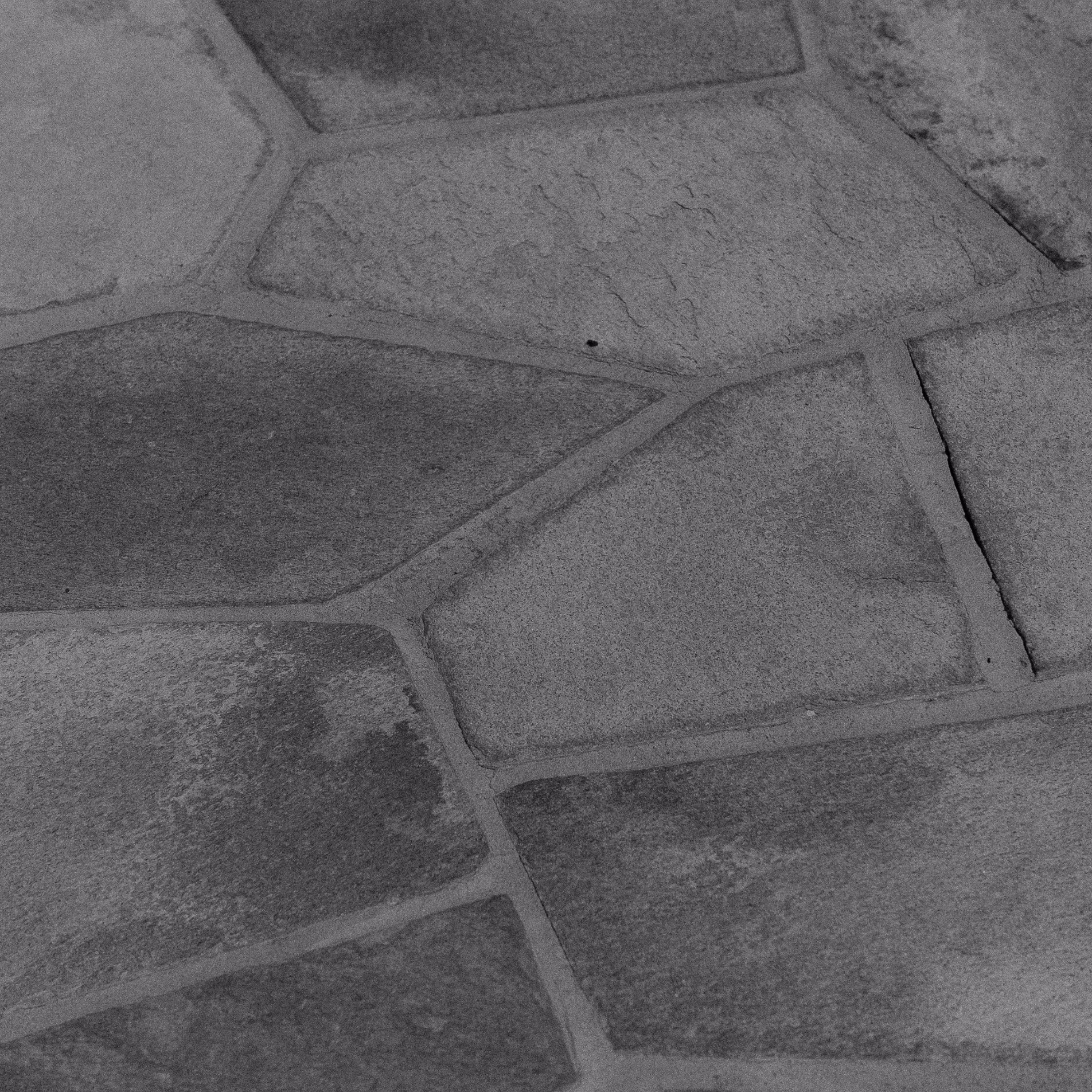 Close-up of stone flooring, a dense material that can absorb and gradually release heat.