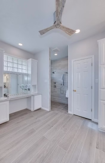 Finished Shirewood bathroom with new tile flooring, custom makeup vanity, walk-in shower and updated lighting.