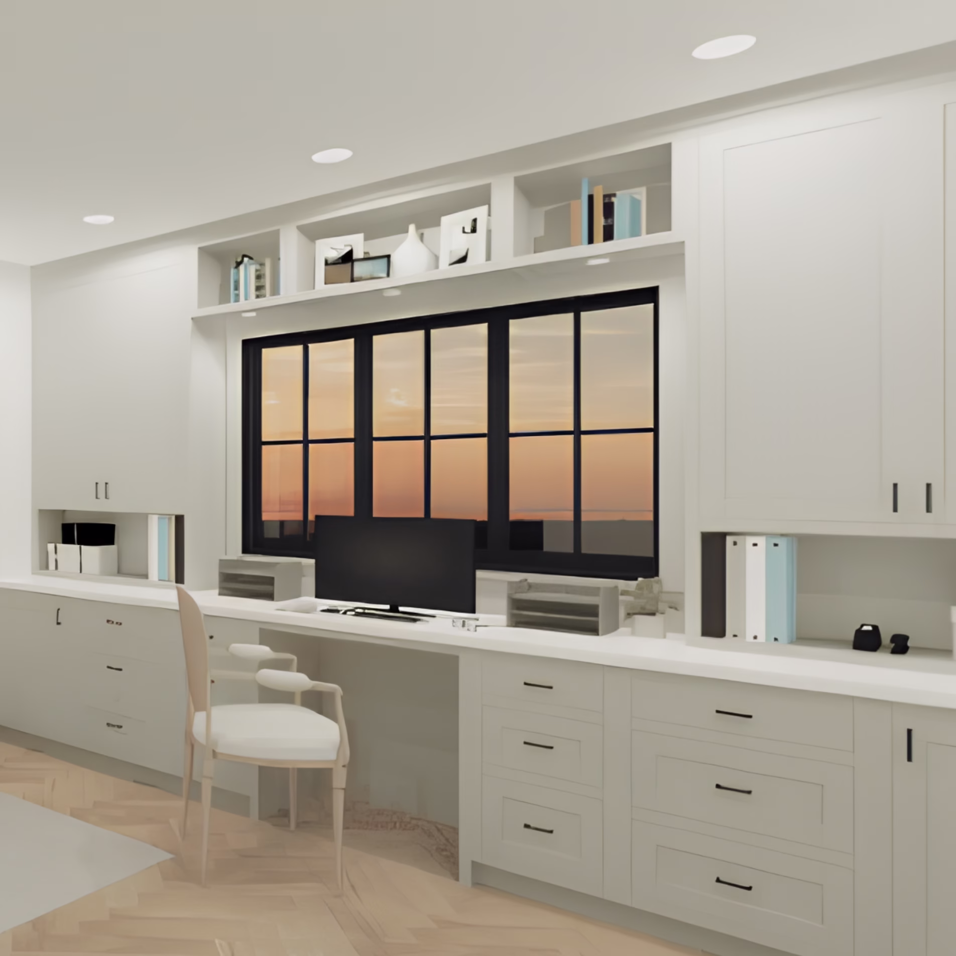 Home office with a built-in white desk, surrounding cabinets, open shelving, and a black-framed window.