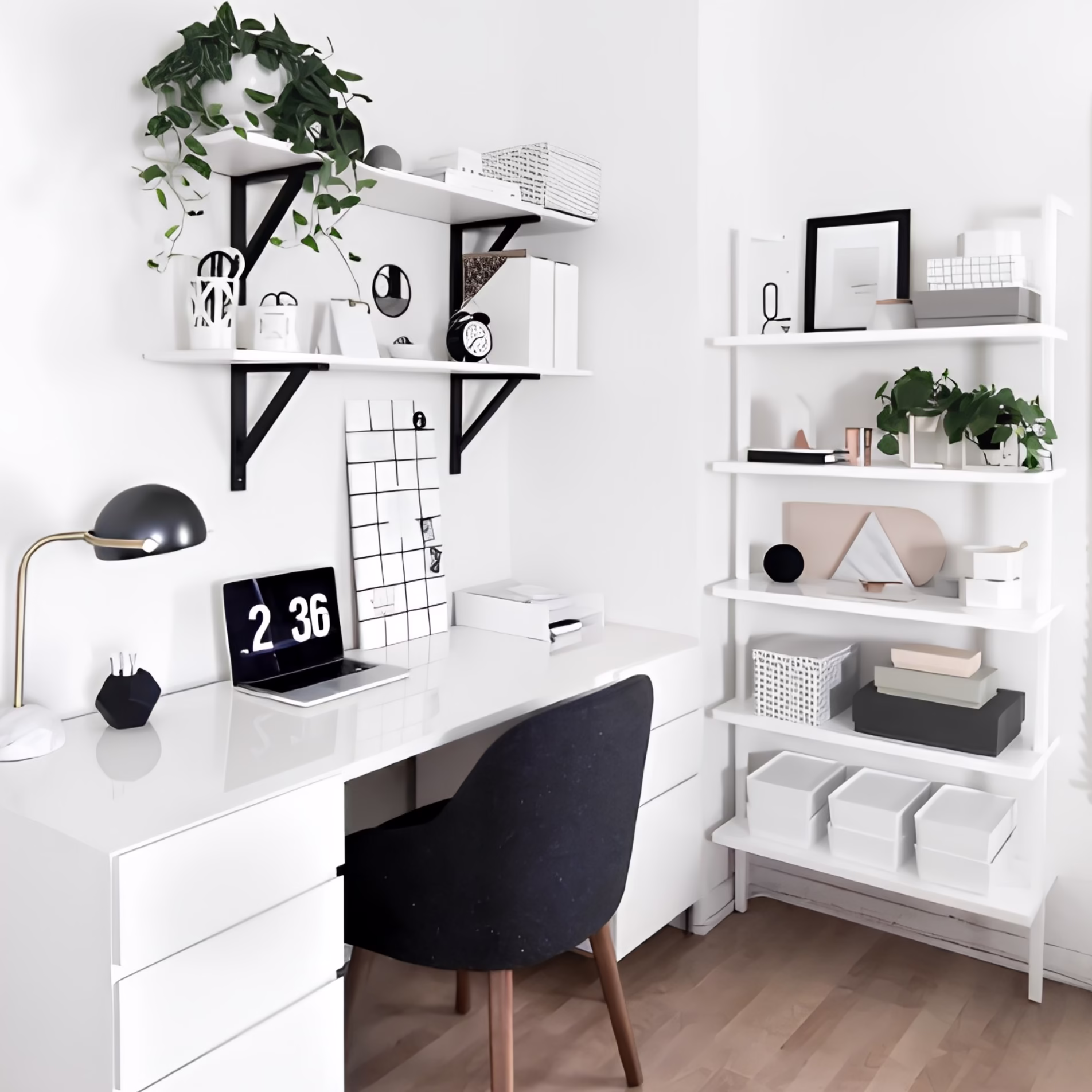 Small home office with a white desk, black chair, floating wall shelves, and an open storage unit.