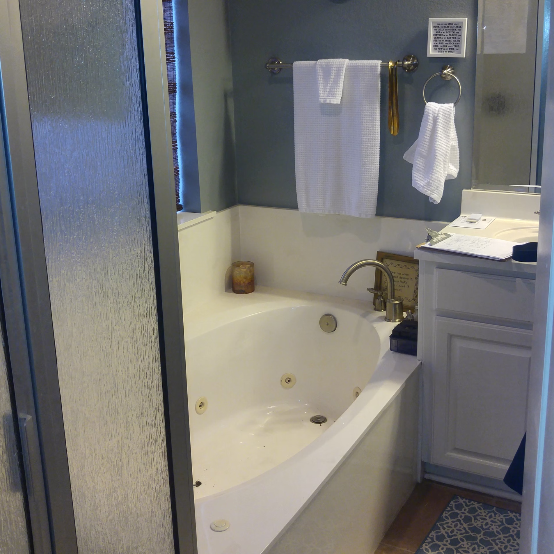 Bathroom before remodeling showing the large jetted tub beside the original compact shower and vanity.